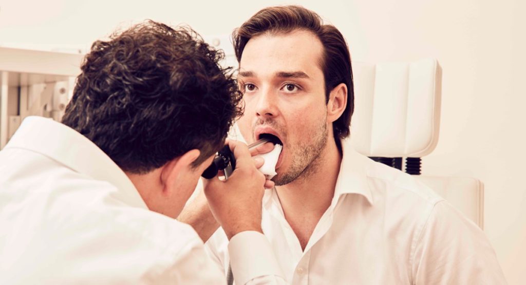 Dr. Wohlt performing a vocal examination